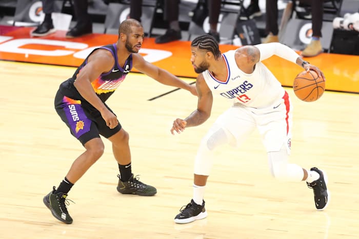Jan 3, 2021; Phoenix, Arizona, USA; Los Angeles Clippers guard Paul George (13) dribbles against Phoenix Suns guard Chris Paul (3) in the second half at Phoenix Suns Arena. Mandatory Credit: Billy Hardiman-USA TODAY Sports